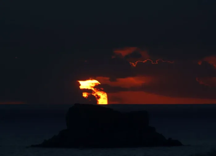Framed Print : The sun sets behind Filfla, a bird reserve and the southernmost island of the Maltese