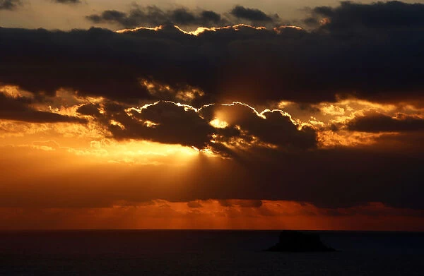 The sun sets over Filfla, the southernmost island of the Maltese archipelago