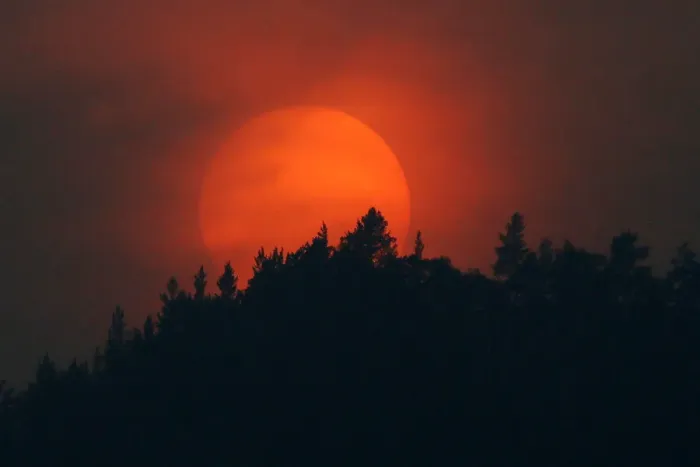 Framed Print : A sun sets over a forest which is shrouded in smoke, from the Siberian Taiga wildfire Framed Print : A sun sets over a forest which is shrouded in smoke, from the Siberian Taiga wildfire