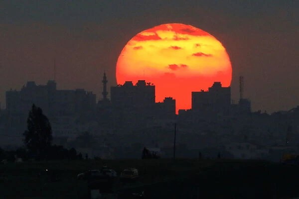 The sun sets over the Gaza Strip, as seen from the Israeli side of the border