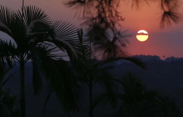 The sun sets over the hills near Japans team base camp in the town of Itu