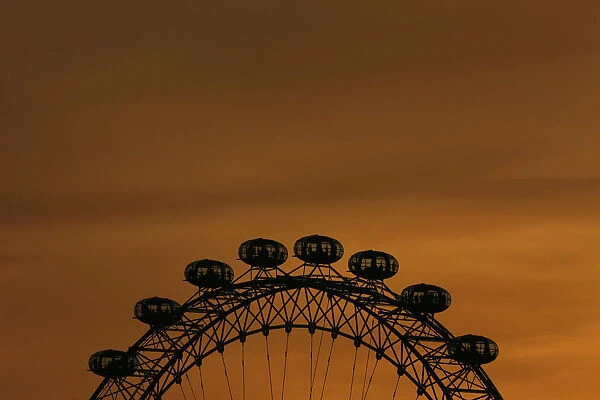 The sun sets behind the London Eye in central London