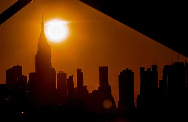 The sun sets on midtown Manhattan during a blackout in New York