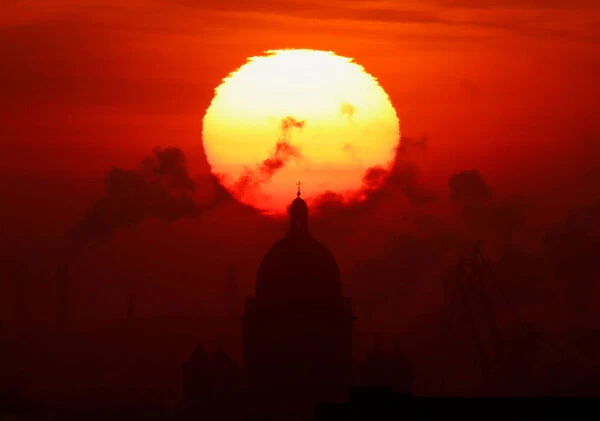 The sun sets over the Saint Isaacs Cathedral in Saint Petersburg