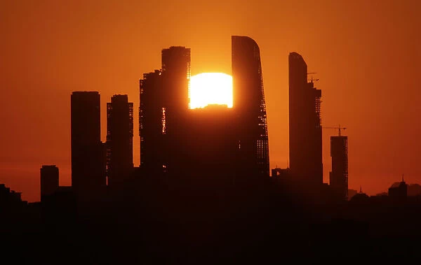 The sun sets behind the skyscrapers of the Moscow International Business Centre in Moscow