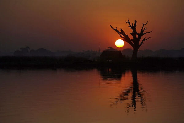 The sun sets over Taungthaman Lake in Amarapura near Mandalay