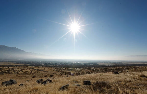 The sun shines above thick smog trapped in Utah Valley in Alpine