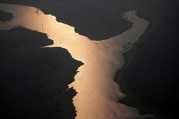 Sunlight is seen over the lake of Samuel Hydroelectric Dam in an area of the Amazon