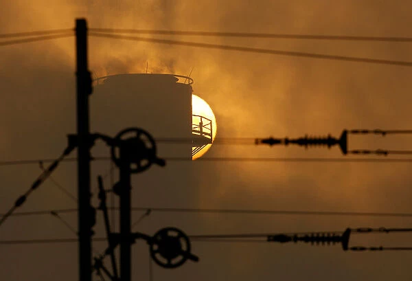 Sunrise is seen near chimney of power plant in Skopje