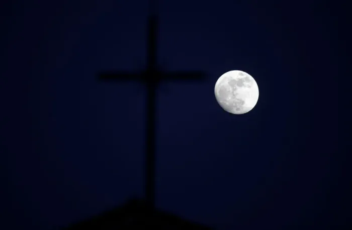 Framed Print : The super moon full moon is seen in front of the cross of a church in Siero