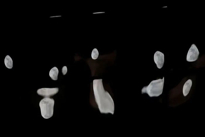 Framed Print : Supermoon full moon reflections are seen on the windows of a business building in Ronda