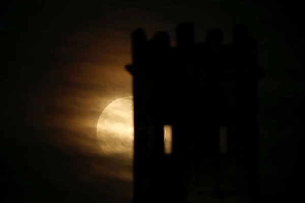 A supermoon full moon rises behind the guard tower on the 17th century San Salvatore