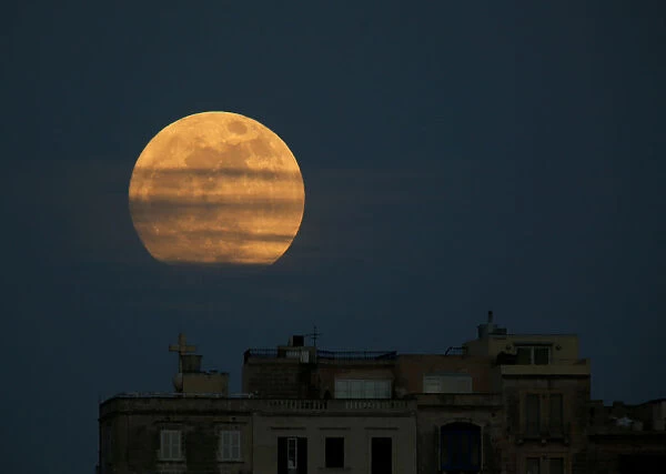 A supermoon full moon is seen rising in Pieta