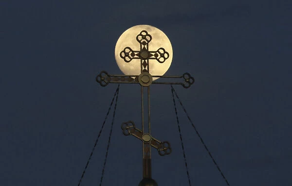 A supermoon rises behind the cross of the Saint Nicholas cathedral in Yevpatoriya
