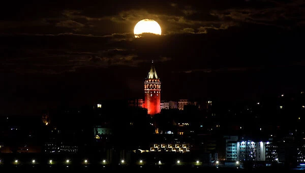 The supermoon is seen over the historical Galata Tower in Istanbul