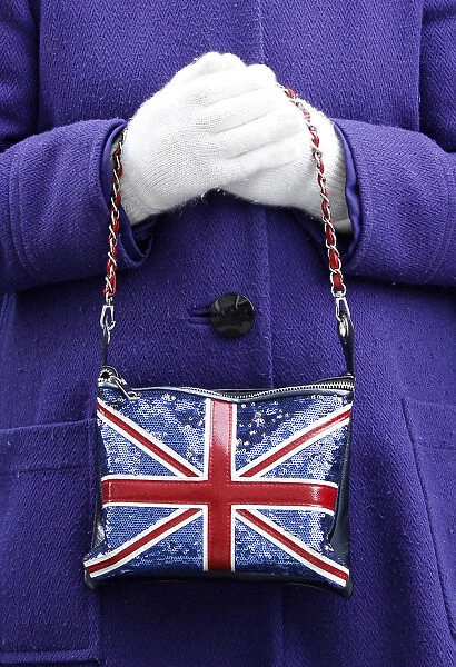 A supporter poses with Union Jack handbag and white golves