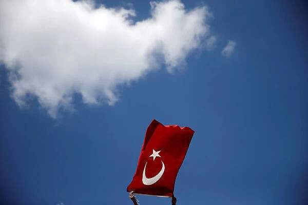 A supporter of Turkish President Tayyip Erdogan waves a Turkish national flag during a