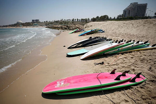 Surfing boards are seen on the beach at the Mediterranean Sea during a summer camp