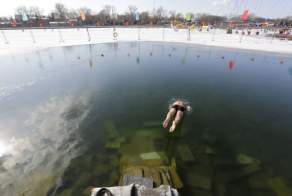 A swimmer jumps into Houhai Lake in central Beijing