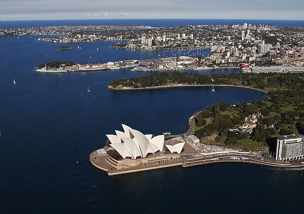 The Sydney Opera House is seen in front of some of the eastern suburbs on a sunny