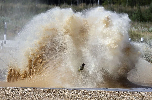 A tank drives through water obstacle on course of Tank Biathlon world championship in
