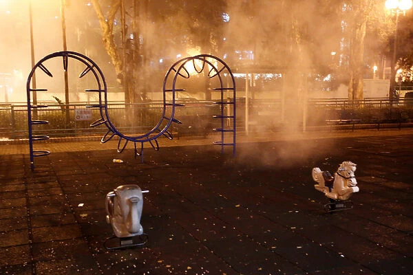 Tear gas is seen at a childrens playground outside a police station in Shatin