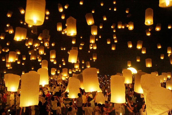 Thais gather to release floating lanterns at Homage to the Lord Buddha during the