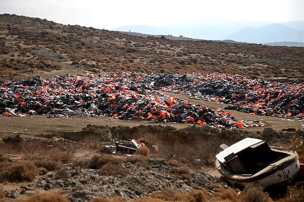 Thousands of lifejackets left by migrants and refugees are piled up at a garbage dump