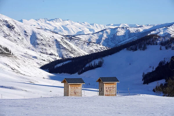 A toilet is seen among mountains covered with snow in Hemu of Altay
