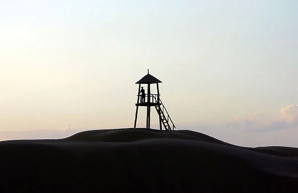 Tourist stands in kiosk used to overlook a park in Tengeri Desert