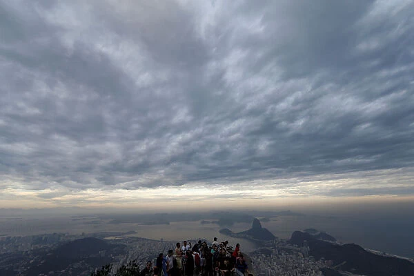 Tourists enjoy the view before a ceremony with the Paralympic torch at the Christ
