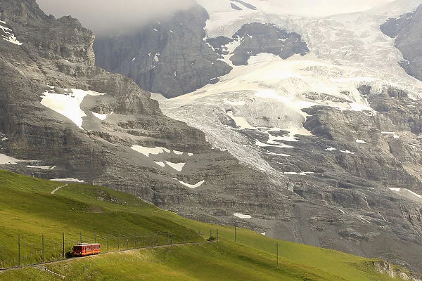 Tourists leave a train of the Jungfraubahn railways at the Kleine Scheidegg station