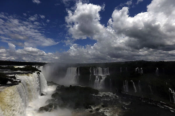 Tourists look at the Iguazu Falls from an observation platform at the Iguazu National