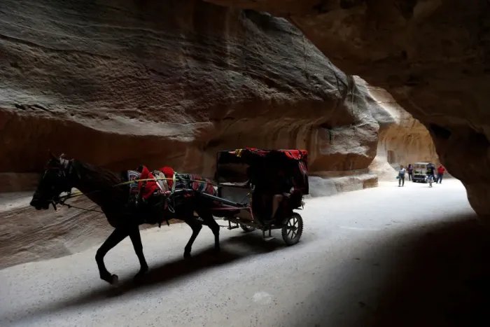 Framed Print : Tourists ride a horse-drawn cart during a tour in the ancient city of Petra, south of Amman Framed Print : Tourists ride a horse-drawn cart during a tour in the ancient city of Petra, south of Amman