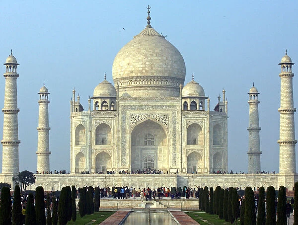Tourists stand in front of the historic Taj Mahal in Agra