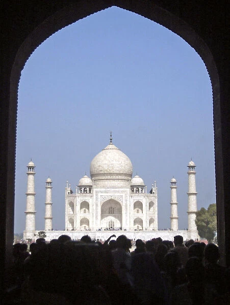 Tourists stand in front of the Taj Mahal in Agra