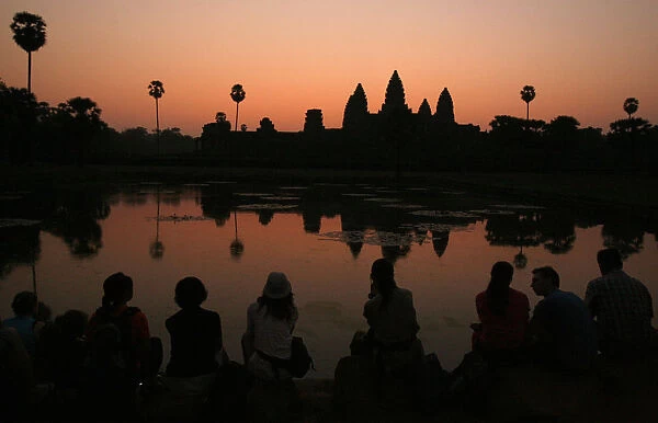 Tourists wait for the sun to rise over Angkor Wat in Siem Reap