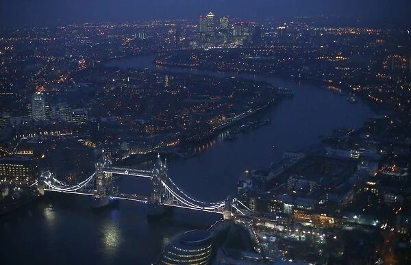 Tower Bridge and the Canary Wharf financial district are seen at dusk in an aerial
