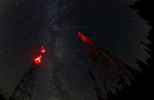 A trace of the Perseid meteor is seen over telecommunication masts in Krasnoyarsk Region