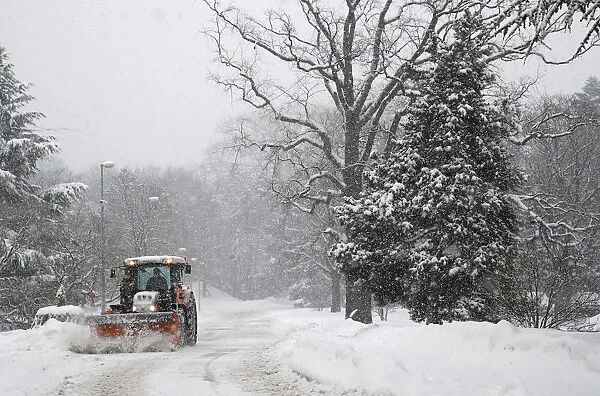 A tractor removes snow at the European headquarters of the United Nations in Geneva