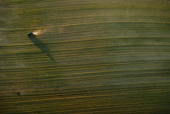 Framed Print : A tractor travels in a field near Donana Natural Reserve, southwest Spain