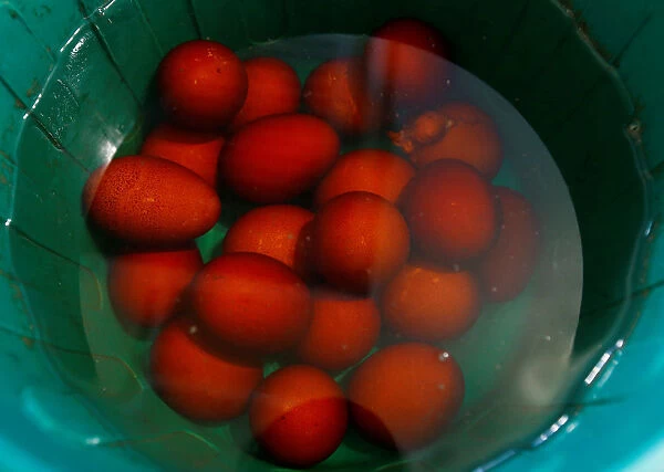 Traditional eggs are cooled in a bucket on the eve of Orthodox Easter in the town of