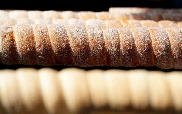Traditional Trdelnik sweet pastries are prepared at a market in Prague