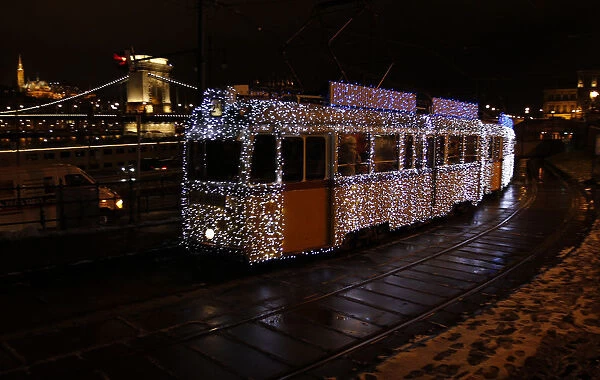 A tram decorated with Christmas lights travels in the centre of Budapest