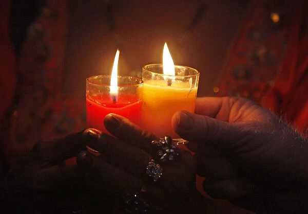 Transgender Pakistanis hold candles in commemoration of World AIDS Day in Karachi