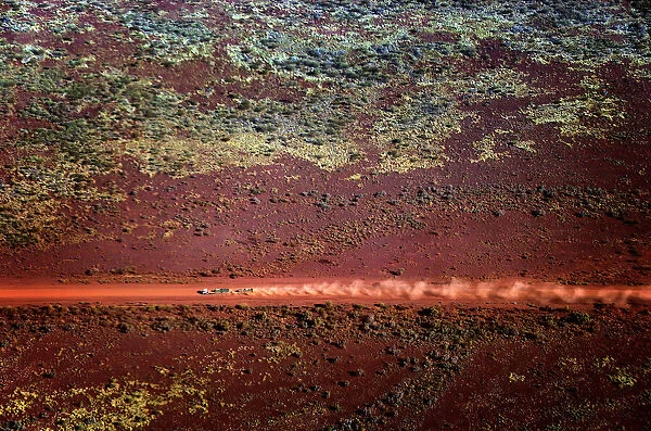 A truck drives along a dirt road in the Pilbara region of Western Australia