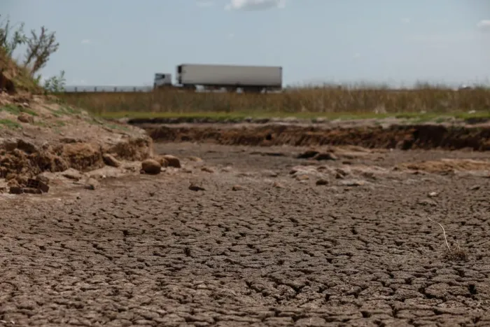 Framed Print : A truck passes by a dried-up creek bed in a drought-affected area near Chivilcoy