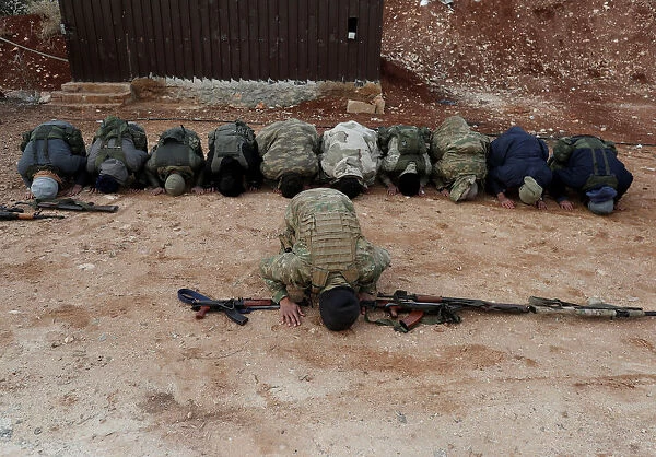 Turkey-backed Free Syrian Army fighters pray at a training camp in Azaz