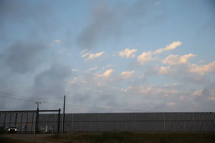 Framed Print : A U. S. Border Patrol agent guards a section of border fence by the Mexico-U. S Framed Print : A U. S. Border Patrol agent guards a section of border fence by the Mexico-U. S