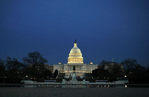 The U. S. Capitol Building is seen across a reflecting pool before President Bush delivers